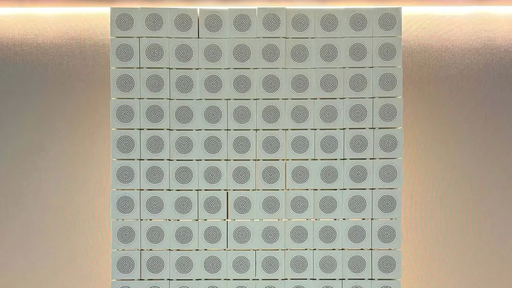 Stack of 149 colorful Ikea Kallsup mini Bluetooth speakers arranged into an acoustic wall of sound inside test lab