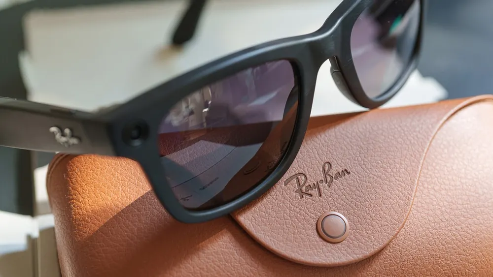 Ray-Ban Meta smart glasses with front-facing camera lens, indicator LED, and open companion charging case