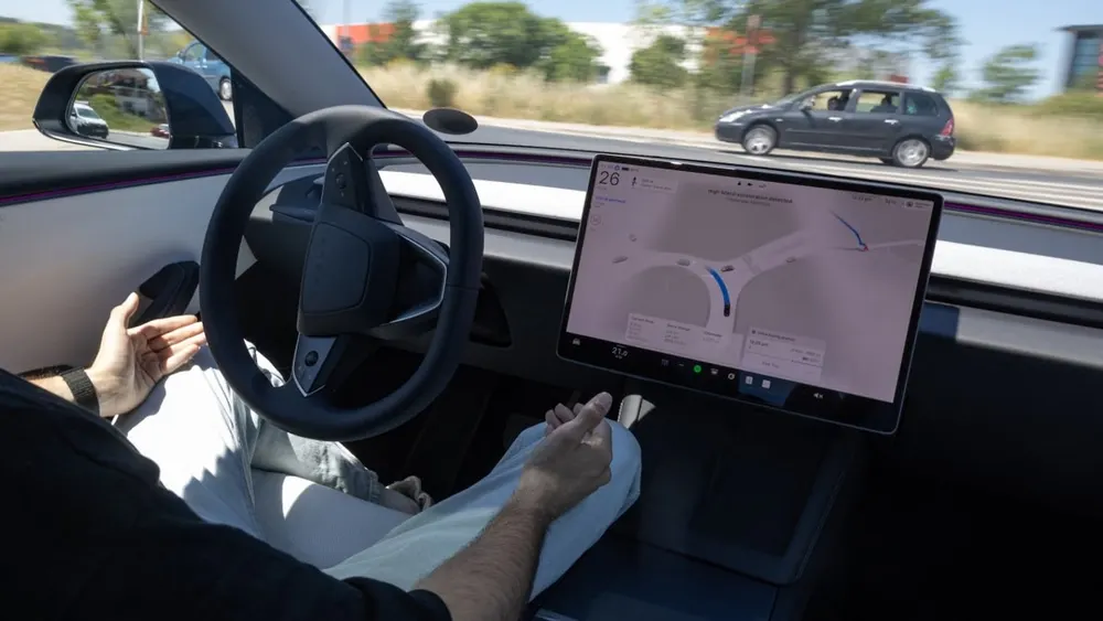 Interior view of Tesla vehicle dashboard displaying real-time Full Self-Driving highway traffic visualization