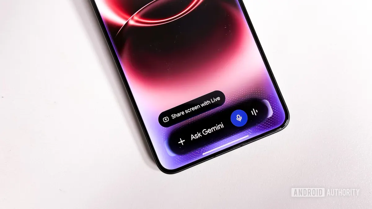 Close-up photograph of the Gemini assistant overlay on an Android phone showing the redesigned Ask Gemini control and glowing visual effects.
