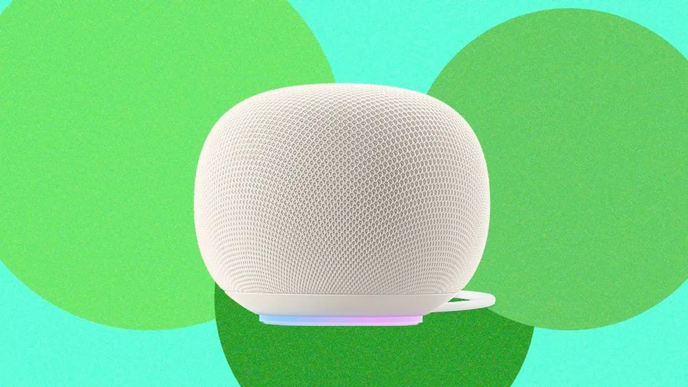 Google Nest and Home smart speakers sitting on a contemporary home tabletop under natural ambient lighting