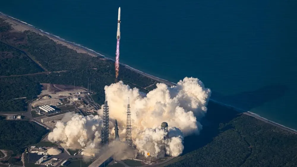 Heavy-lift orbital launch vehicle ascending from launch pad complex during orbital mission