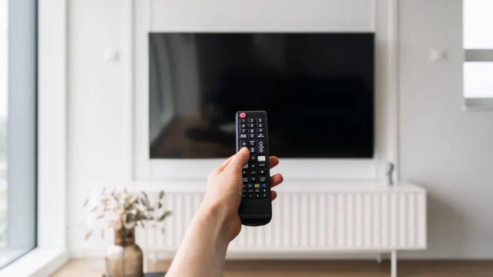 Smart TV television display displaying streaming user interface in home setting