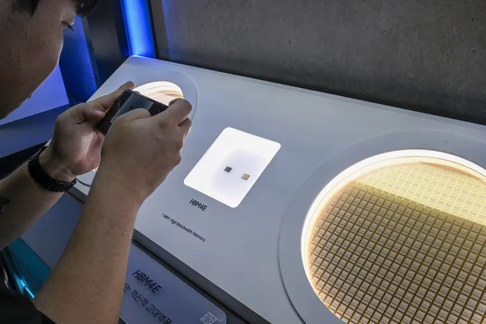 Official exhibition display showing Samsung Electronics HBM4E high-bandwidth memory semiconductor and silicon wafer