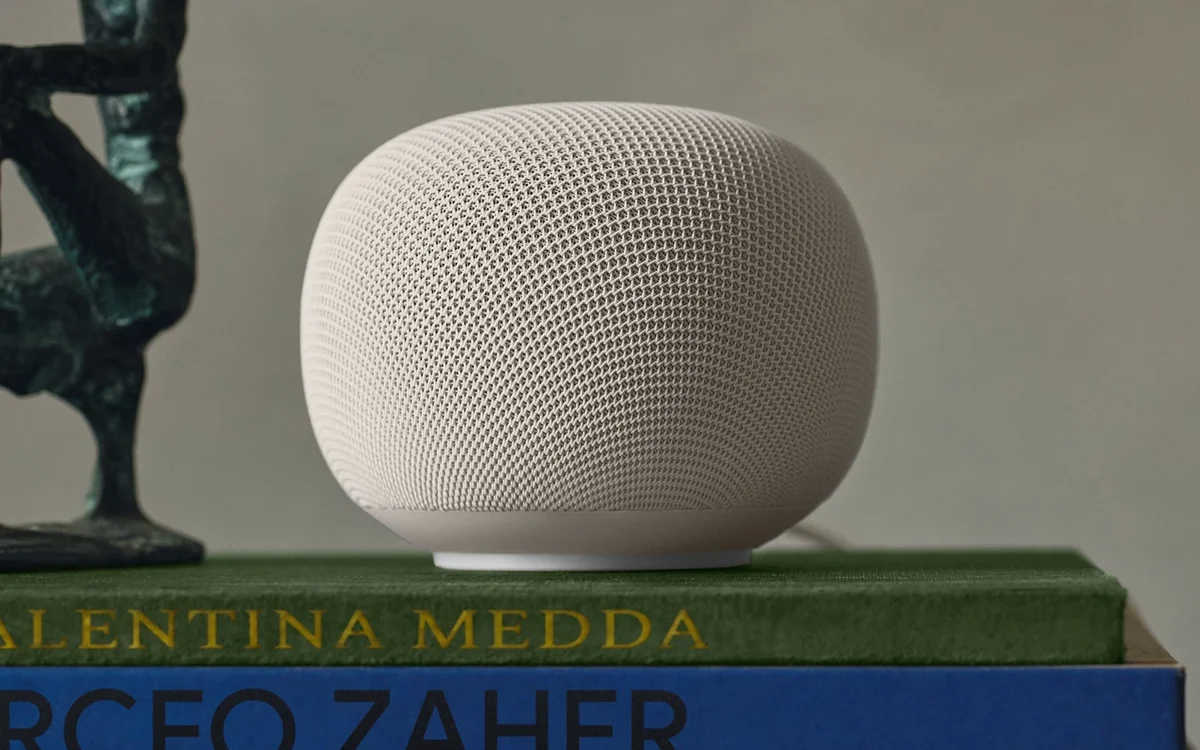 Google Home Speaker in Porcelain, shown in full on a stack of books